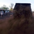 A worker watches as a loader unloads coal at a yard on the outskirts of Ahmedabad. Source: Reuters/Amit Dave