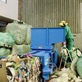 Recyclable items collected and sorted at the African Reclaimers Organisation’s sorting centre are compressed using a baler machine before being sold to buy-back centres. Photo: Masego Mafata / GroundUp
