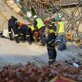A rescue worker removes rubble from the site where construction workers are trapped under a building that collapsed in George. Source: Reuters/Esa Alexander