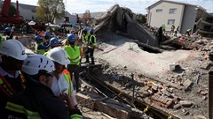Rescuers work to rescue construction workers trapped under a building that collapsed in George. Source: Reuters/Esa Alexander