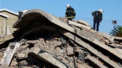 Rescuers work to rescue construction workers trapped under a building that collapsed in George. Source: Reuters/Esa Alexander