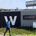 A man walks past the Woolworths truck entrance in Cape Town, South Africa, 26 February 2024. Source: REUTERS/Esa Alexander/file photo.