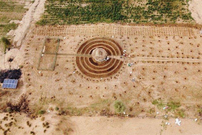 An aerial view shows participants of a Tolou Keur programme working on a newly built Tolou Keur garden in Boki Diawe, within the Great Green Wall area, in Matam region, Senegal, 10 July 2021. Picture taken with a drone. Reuters/Zohra Bensemra/File Photo