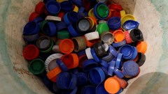 Caps collected from used plastic bottles are stored in a bucket at the Waste museum in Ibadan, Oyo State, Nigeria, 23 February 2022. Reuters/Temilade Adelaja/File Photo