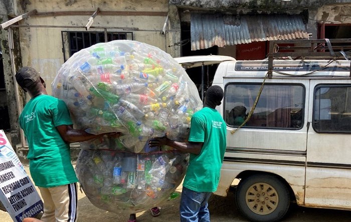 Employees load a sack of plastic bottles onto a bus after collection from a dump site in Port Harcourt, Nigeria, 31 October 2022. Reuters/Seun Sanni/File Photo