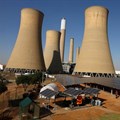Solar panels are seen near the cooling towers of a retired coal-fired Komati Power Station, operated by Eskom, near Komati village, in the Mpumalanga province in South Africa, 9 May 2024. Reuters/Siphiwe Sibeko/File Photo