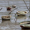 A fisherman walks toward his boat during low tide, in Maputo, 28 September 2010. Reuters/ Goran Tomasevic/File Photo