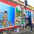 Local artists apply branding to the Yellow Tuck Shop spaza store in Alexandra, north of Johannesburg (Image supplied)