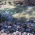 The Gcuwa River at Butterworth has been contaminated by constant flows of raw sewage for eight years, and has become a dump site. Photo: Manqulo Nyakombi / GroundUp