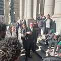 Outside the Western Cape High Court, Ndifuna Ukwazi attorney Jonty Cogger speaks to applicants urgently seeking an interdict preventing PRASA from evicting them from land they have occupied for years. Photo: Sandiso Phaliso / GroundUp