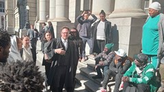 Outside the Western Cape High Court, Ndifuna Ukwazi attorney Jonty Cogger speaks to applicants urgently seeking an interdict preventing PRASA from evicting them from land they have occupied for years. Photo: Sandiso Phaliso / GroundUp