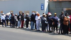 Striking Mister Sweet workers queued on Wednesday for food brought by supporters. Photo: Kimberly Mutandiro / GroundUp