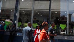 Pedestrians walk outside the Safaricom mobile phone customer care centre during the launch of its 5G internet service in the central business district of Nairobi, Kenya, 27 October 2022. Reuters/Monicah Mwangi/File Photo