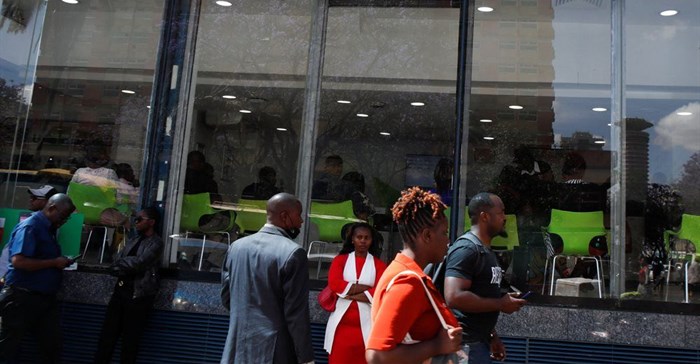 Pedestrians walk outside the Safaricom mobile phone customer care centre during the launch of its 5G internet service in the central business district of Nairobi, Kenya, 27 October 2022. Reuters/Monicah Mwangi/File Photo