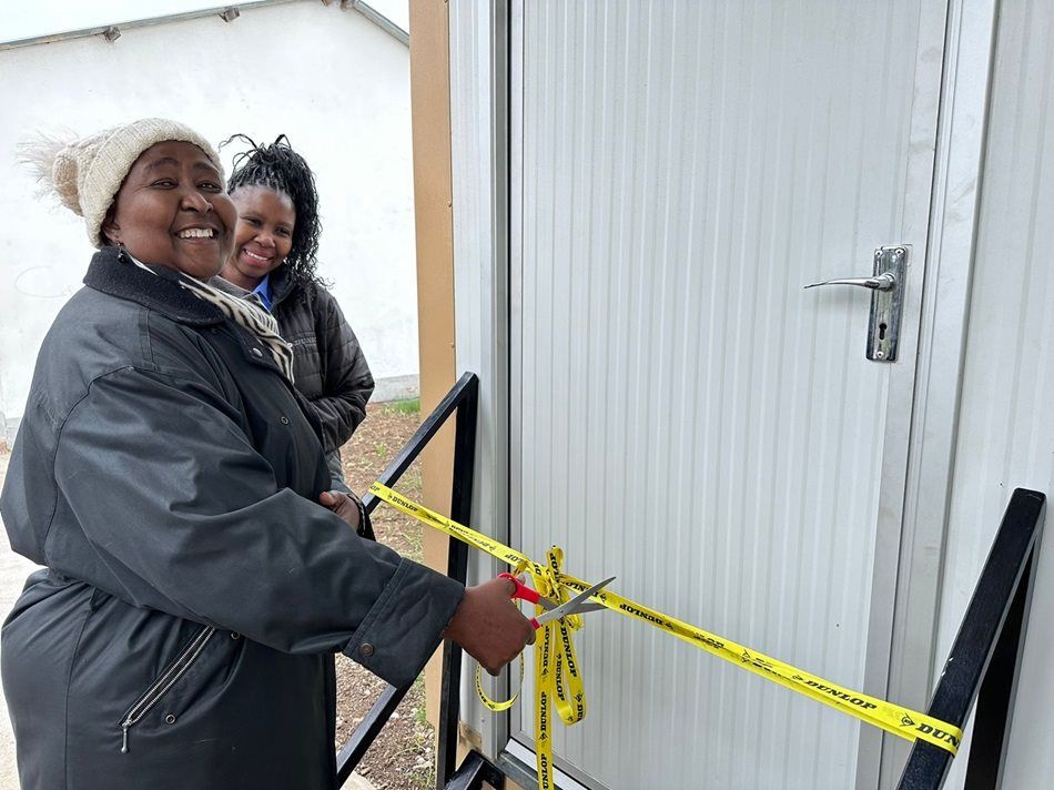 Headmistress Sibongile Tshabalala (front) officially opens one of the new classrooms, joined by Thuli Gasa, Dunlop Tyres SA manager: Strategic Planning.