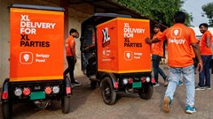 Swiggy gig workers assist another worker as he parks an electric three-wheeler delivery scooter during a promotional event in Mumbai. Source: Reuters/Francis Mascarenhas