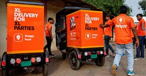 Swiggy gig workers assist another worker as he parks an electric three-wheeler delivery scooter during a promotional event in Mumbai. Source: Reuters/Francis Mascarenhas