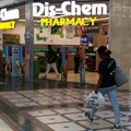 A person walks past a Dis-Chem Pharmacy outlet in Cape Town, South Africa, 22 February 2024. Reuters/Esa Alexander/ File Photo
