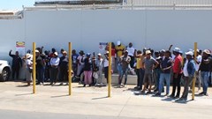 Striking workers gather outside the Mister Sweet factory in Germiston. Photo: Kimberly Mutandiro / GroundUp