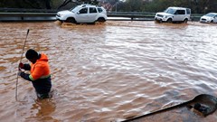 A municipal worker attempts to unclog a flooded road in Newlands during heavy rains in Cape Town, South Africa, 9 July 2024. Reuters/Esa Alexander/File Photo