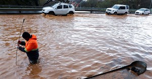 A municipal worker attempts to unclog a flooded road in Newlands during heavy rains in Cape Town, South Africa, 9 July 2024. Reuters/Esa Alexander/File Photo