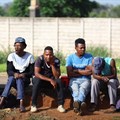 Job seekers wait beside a road for casual work offered by passing motorists in Eikenhof, south of Johannesburg, South Africa, 20 November 2023. Reuters/Siphiwe Sibeko/File photo