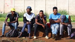 Job seekers wait beside a road for casual work offered by passing motorists in Eikenhof, south of Johannesburg, South Africa, 20 November 2023. Reuters/Siphiwe Sibeko/File photo