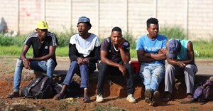 Job seekers wait beside a road for casual work offered by passing motorists in Eikenhof, south of Johannesburg, South Africa, 20 November 2023. Reuters/Siphiwe Sibeko/File photo