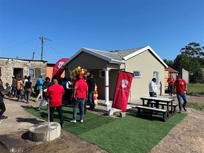 Government officials, BB Bakeries staff and community members arriving for the ribbon cutting ceremony at the newly built home
