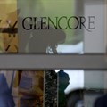 An employee of a private security company stands in front of the logo of commodities trader Glencore during the company's annual shareholder meeting in Cham, Switzerland. Source: Reuters/Arnd Wiegmann