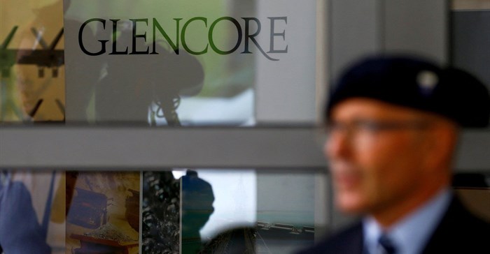 An employee of a private security company stands in front of the logo of commodities trader Glencore during the company's annual shareholder meeting in Cham, Switzerland. Source: Reuters/Arnd Wiegmann