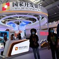 People walk past a booth of China Development Bank during the 2022 China International Fair for Trade in Services (CIFTIS) in Beijing. Source: Reuters/Tingshu Wang