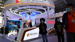 People walk past a booth of China Development Bank during the 2022 China International Fair for Trade in Services (CIFTIS) in Beijing. Source: Reuters/Tingshu Wang