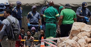 Rescued miners are seen as they are processed by police after being rescued at the mine shaft where rescue operations are ongoing as attempts are made to rescue illegal miners who have been underground for months, in Stilfontein. Source: Reuters/Ihsaan Haffejee