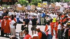 In the 2000s activists across the world campaigned for antiretroviral treatment to be made available to people with HIV. One of the consequences of this was PEPFAR, the United States government’s foreign aid HIV programme. Since 2003 it has saved millions of lives. But now its future is unclear. Photo from the Treatment Action Campaign’s march for HIV treatment in Cape Town on 14 February 2003. (photographer unknown)