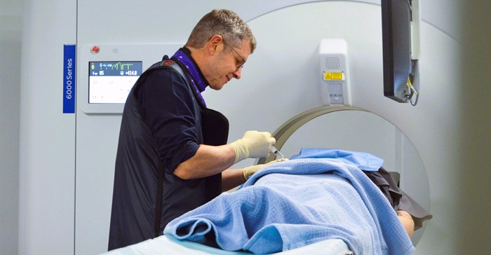 Source: Supplied. Dr Winter performing a CT-guided interventional procedure.