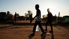Source: Reuters. Young residents carry water home after filling up a bottle at a community filling station in the informal settlement of Kanana after individuals died from cholera in Hammanskraal, South Africa, 24 May, 2023.