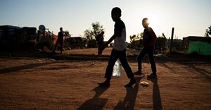 Source: Reuters. Young residents carry water home after filling up a bottle at a community filling station in the informal settlement of Kanana after individuals died from cholera in Hammanskraal, South Africa, 24 May, 2023.