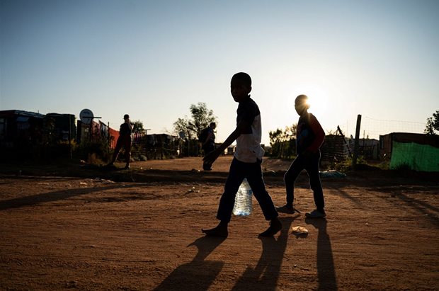 Source: Reuters. Young residents carry water home after filling up a bottle at a community filling station in the informal settlement of Kanana after individuals died from cholera in Hammanskraal, South Africa, 24 May, 2023.