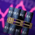 Miniatures of oil barrels and a rising stock graph are seen in this illustration. Source: Reuters/Dado Ruvic