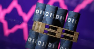Miniatures of oil barrels and a rising stock graph are seen in this illustration. Source: Reuters/Dado Ruvic