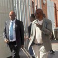 Former Prasa acting CEO Mthuthuzeli Swartz (right) exits the Gqeberha Regional Court with his advocate, Mzwamadoda Mnyani. Photo: Steve Kretzmann / GroundUp