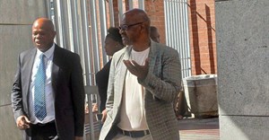 Former Prasa acting CEO Mthuthuzeli Swartz (right) exits the Gqeberha Regional Court with his advocate, Mzwamadoda Mnyani. Photo: Steve Kretzmann / GroundUp