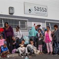 Sassa presented its audit action plan to Parliament on Wednesday. Archive photo of people queueing for social grants in Eerste River in 2018. Photo: Ashraf Hendricks / GroundUp