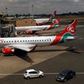Kenya Airways planes are seen through a window at the Jomo Kenyatta international airport in Nairobi, Kenya, 1 August 2020. Reuters/Njeri Mwangi/File Photo