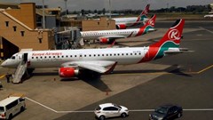 Kenya Airways planes are seen through a window at the Jomo Kenyatta international airport in Nairobi, Kenya, 1 August 2020. Reuters/Njeri Mwangi/File Photo