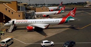 Kenya Airways planes are seen through a window at the Jomo Kenyatta international airport in Nairobi, Kenya, 1 August 2020. Reuters/Njeri Mwangi/File Photo