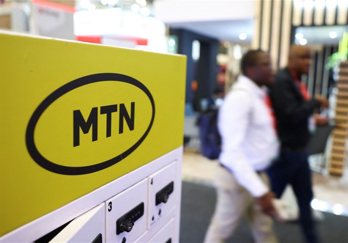 Delegates walk past the MTN logo at the Investing in African Mining Indaba 2024 conference in Cape Town, South Africa, on 7 February 2024. Reuters/Esa Alexander/File Photo