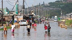 People walk on a flooded road after heavy rains in Durban, South Africa, 20 February 2025. Reuters/Rogan Ward/File Photo