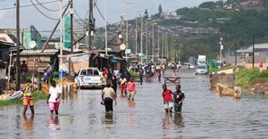 People walk on a flooded road after heavy rains in Durban, South Africa, 20 February 2025. Reuters/Rogan Ward/File Photo